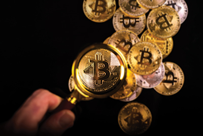 bitcoin_cryptocurrency_magnifyingglass_iStock-931140206